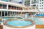 ID 3185 QUEEN ELIZABETH 2 (1969/70327grt/IMO 6725418) - The pool area aft on One Deck consisting of two whirlpools, a paddling/splash pool for chldren and a swimming pool.